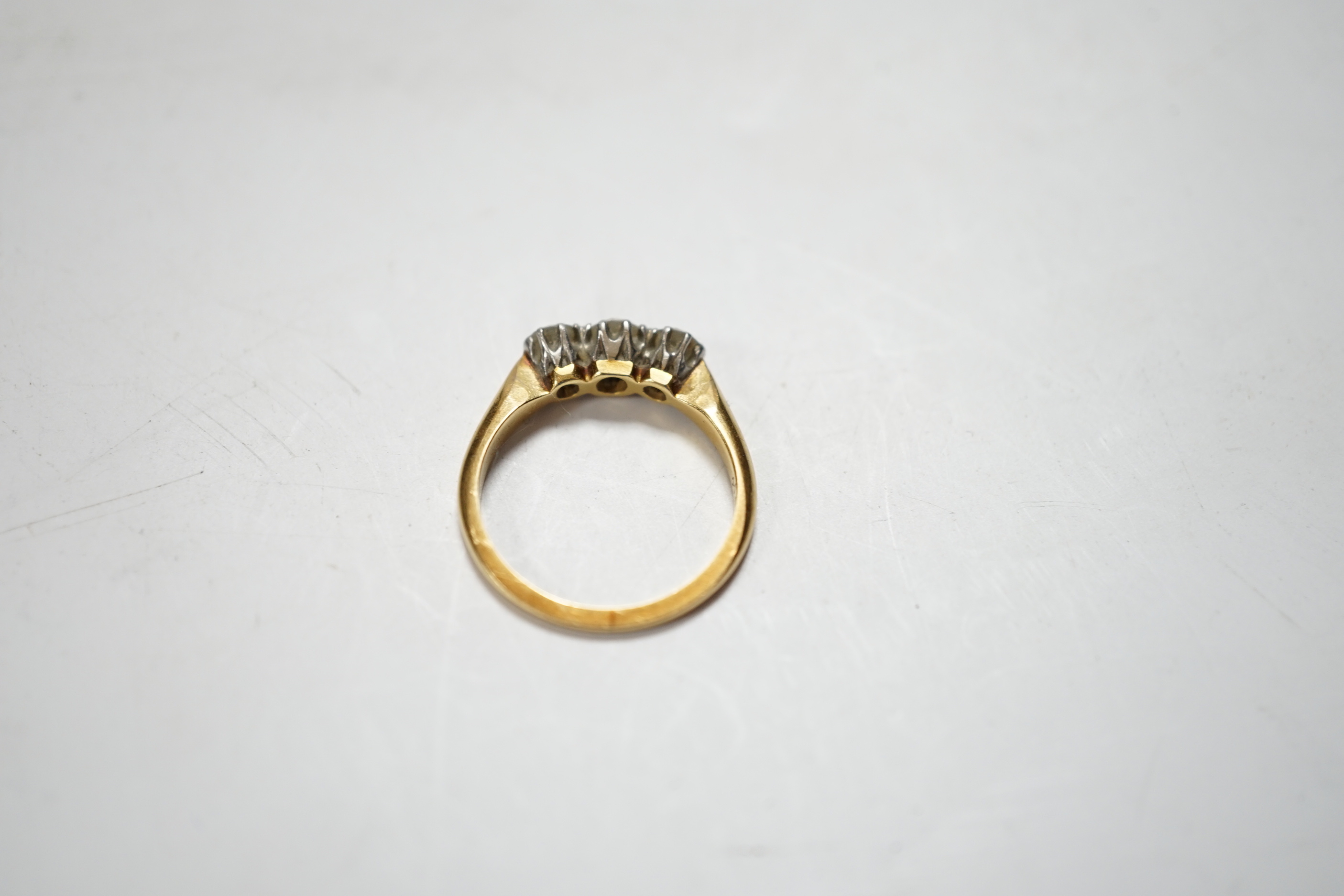 An 18ctct & plat, three stone diamond set ring, size L, gross weight 3.1 grams.